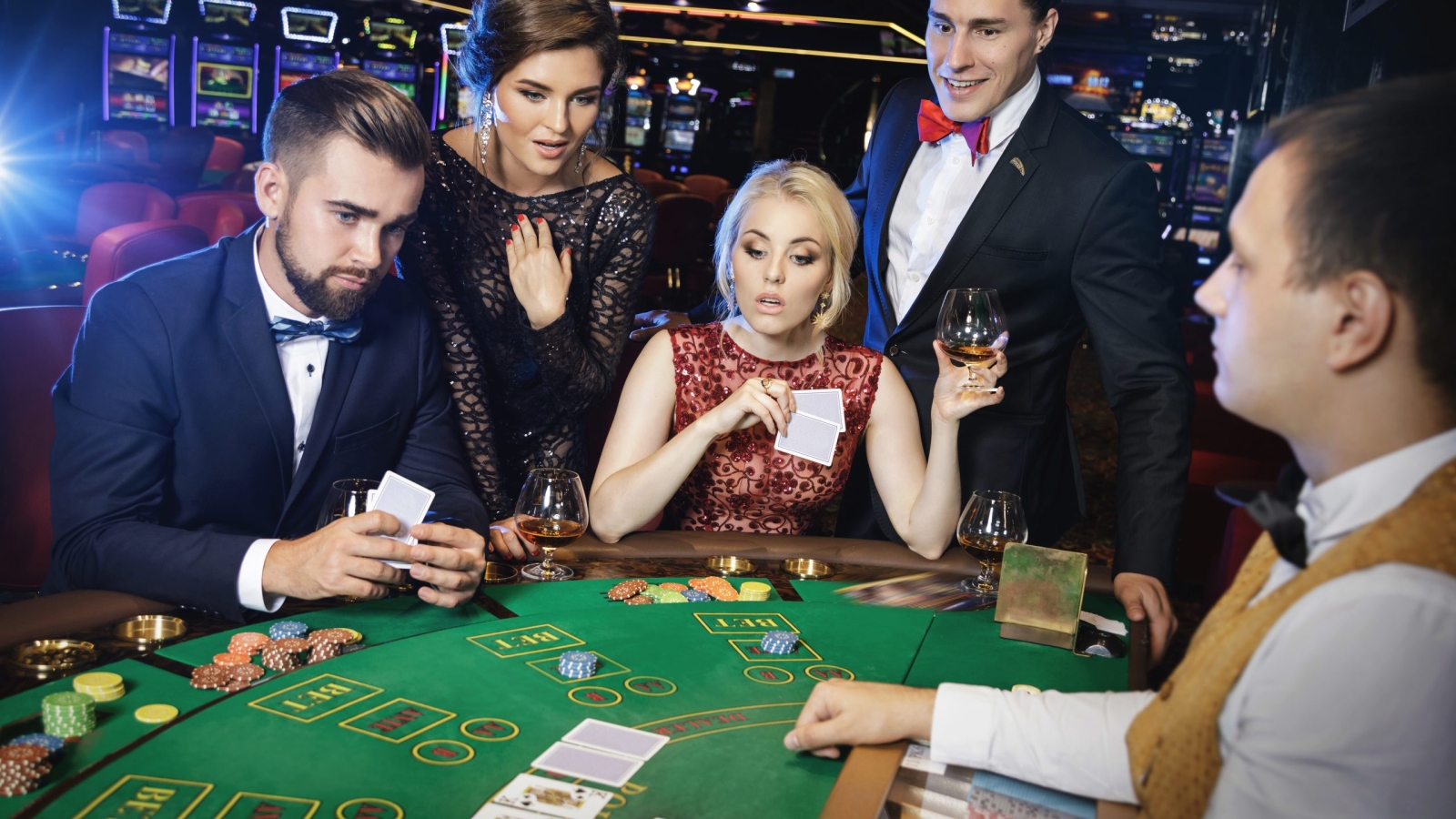 Group of young rich people is playing poker in the casino